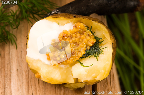 Image of Baked potato with sour cream, grain Dijon mustard and herbs