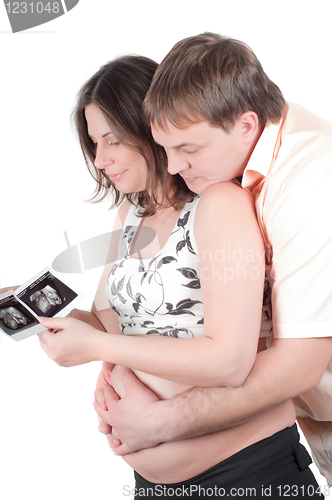 Image of Couple holding a sonogram of their child