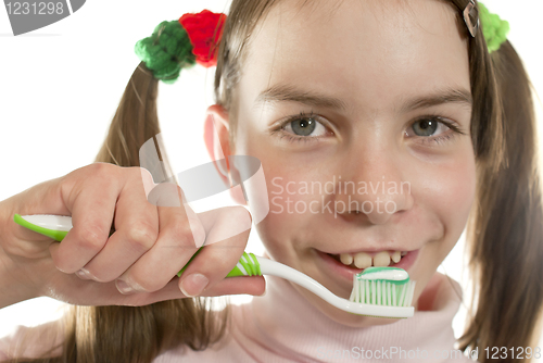 Image of Teen girl with toothbrush isolated on white