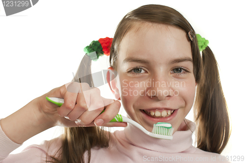 Image of Teen girl with toothbrush isolated on white