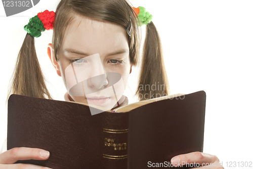Image of Teen girl reading the Bible isolated on white