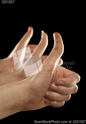 Image of Three hands gesturing fingers up on black background