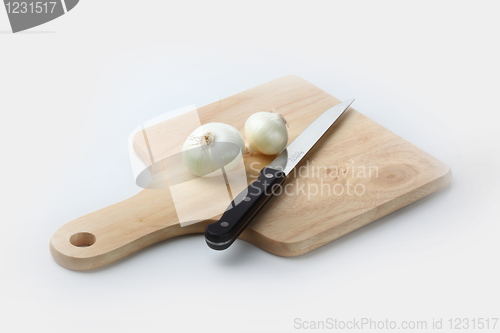 Image of Cutting onion on the wooden board