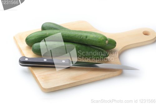 Image of Cutting cucumbers on the wooden board