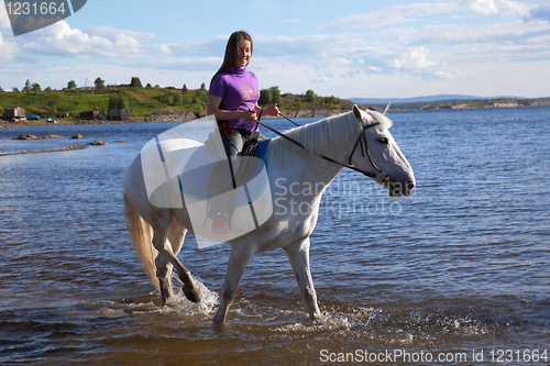Image of The girl led the horse to swim