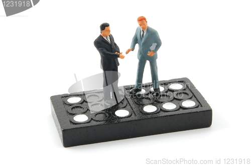 Image of business man on domino isolated