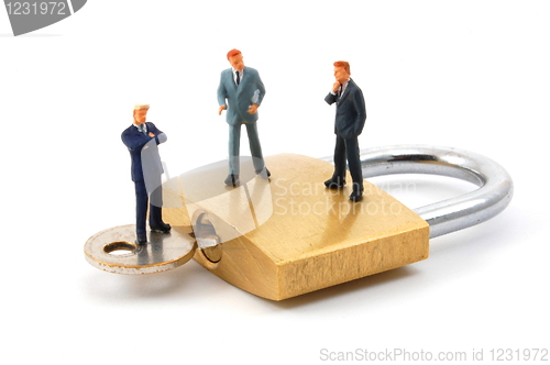 Image of business man on security padlock 