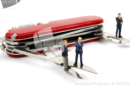 Image of business people on penknife