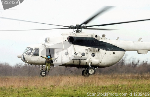 Image of paratroopers  jump from helicopter