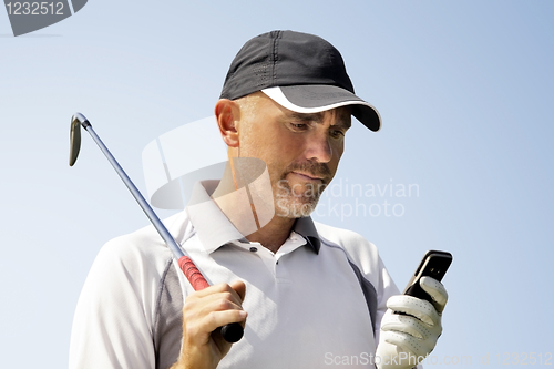 Image of Golfer using mobile phone