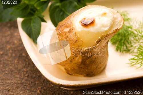 Image of Baked potato with sour cream and fresh dill