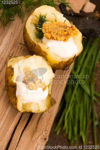 Image of Baked potato with sour cream, grain Dijon mustard and herbs