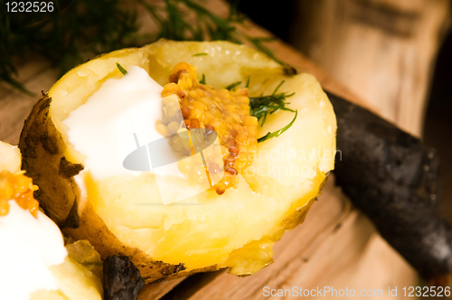 Image of Baked potato with sour cream, grain Dijon mustard and herbs