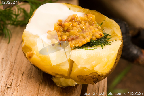 Image of Baked potato with sour cream, grain Dijon mustard and herbs