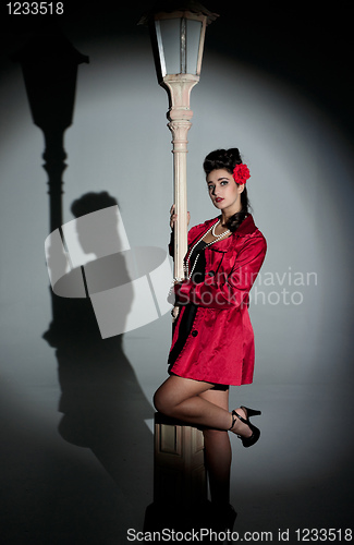 Image of young woman and lightpole