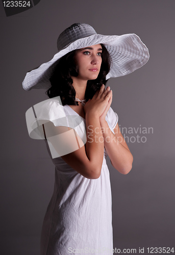 Image of young woman in white dress and hat