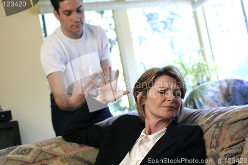 Image of man offering drink to woman