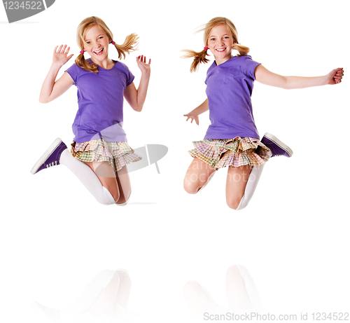 Image of Happy identical twins jumping and laughing