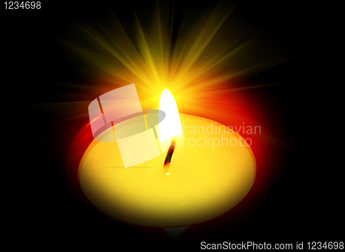 Image of burning candle in the dark