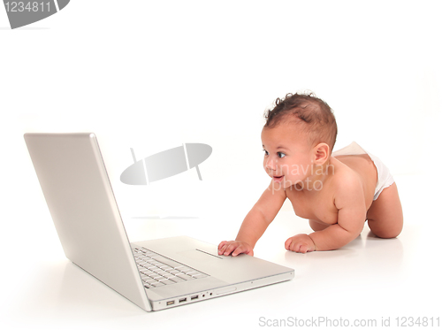 Image of Sweet Cute Baby Boy Playing With a Laptop Computer on White