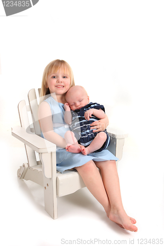 Image of Preschooler Holding Her Newborn Baby Brother on White Background