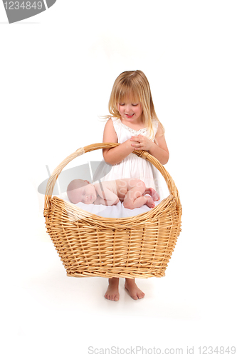 Image of Young Girl Holding Her Baby Infant Brother