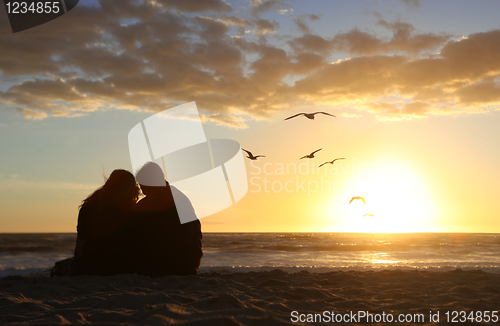 Image of Happy Couple Watching the Sunset in Love on the Beach