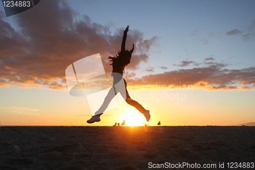 Image of Beautiful Woman on the Beach at Sunset