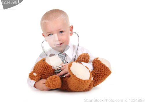 Image of Sweet Little Boy Caring for His Teddy Bear