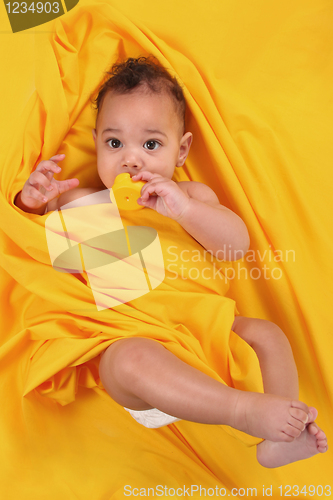 Image of Cute Ethnic Baby Holding a Rubber Duckie