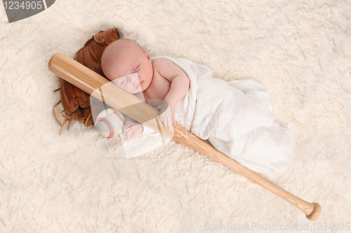 Image of Swaddled Sleeping Baby Boy With a Baseball Bat