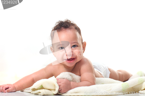 Image of Curly Haired Baby Boy on Stomach With Blankets