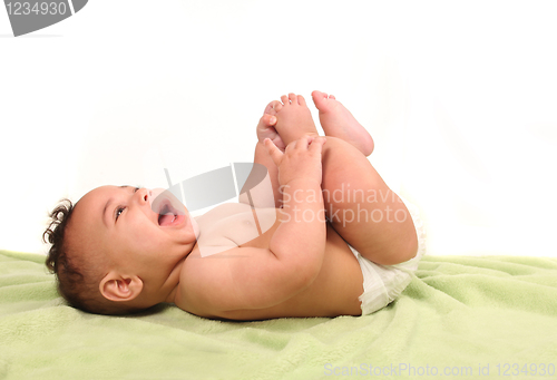Image of Infant Happily Shrieking in Laughter While Lying Down