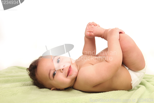 Image of Infant Boy Holding His Foot on White Background