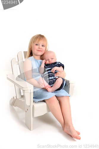 Image of Sister Holding Her Newborn Baby Brother on White