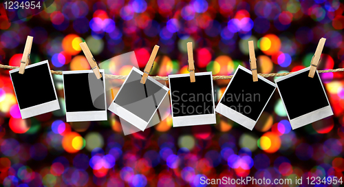 Image of Photos Hanging on a Rope With Holiday Background
