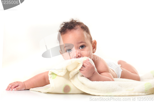 Image of Infant Boy on Stomach Playing With Blankets