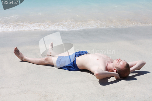 Image of Man relaxing on beach