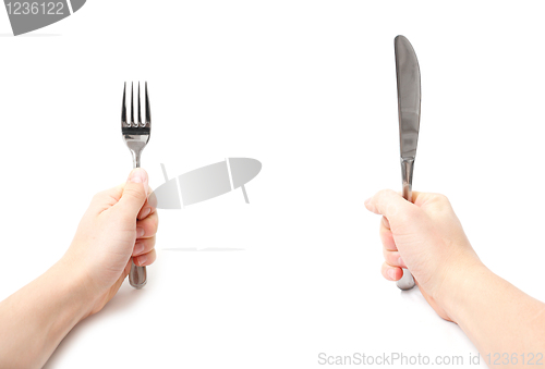 Image of Hands holding knife and fork