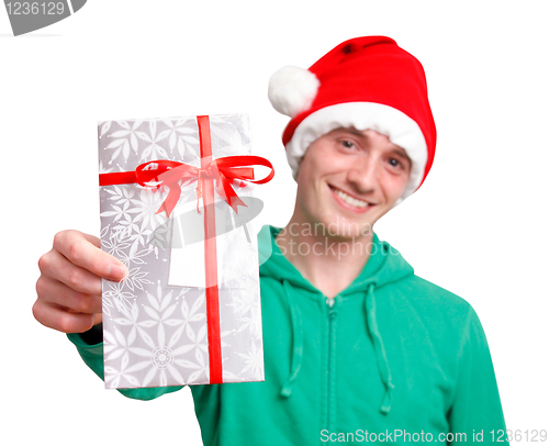 Image of Man with santa hat holding christmas present