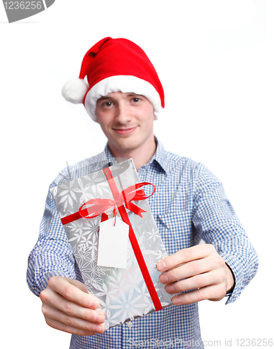 Image of Man with santa hat holding christmas present