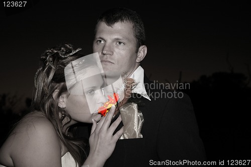 Image of Bride smelling a flower