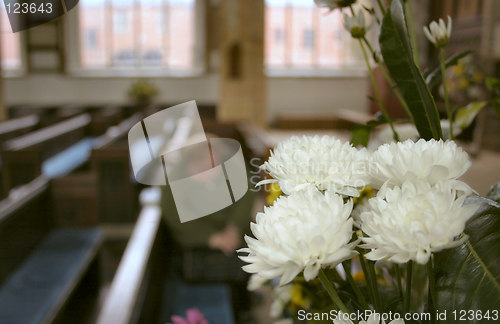 Image of flowers in church and a person in prayer