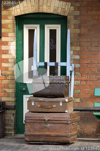 Image of old trunks in front of a  green door