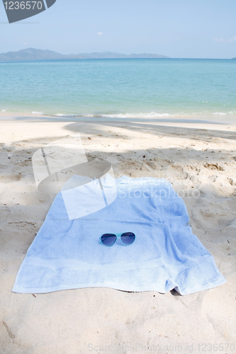 Image of Sunglasses and towel