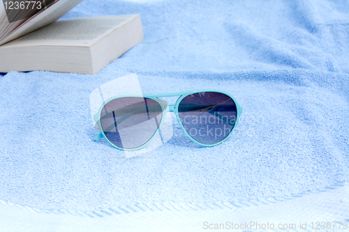 Image of Sunglasses and towel