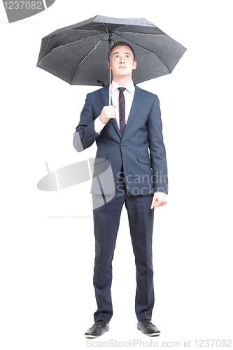 Image of Business man under umbrella