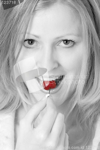 Image of Pretty woman eating a cherry