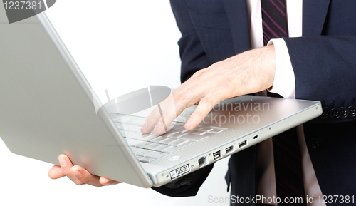Image of Business man with laptop typing