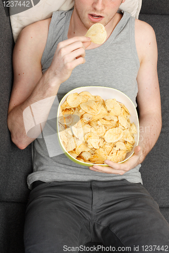 Image of Man eating chips